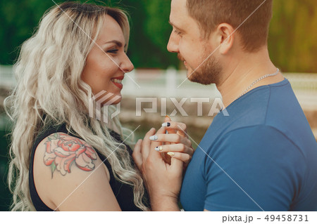 Beautiful couple spend time in a summer park 49458731