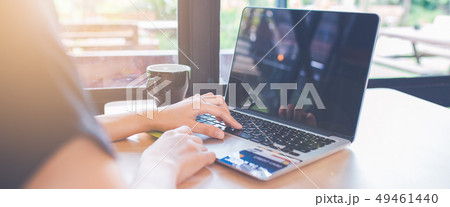 Woman hand is using a laptop computer in office. Woman hand is using a laptop computer in office. 49461440
