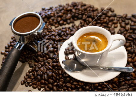 Cup of espresso coffee and portafilter on coffee  49463963