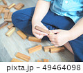 Close up of kid's hand playing with wooden blocks 49464098