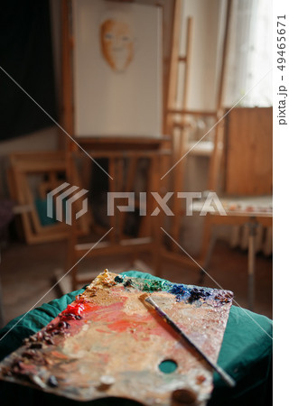 Color palette and brush, easel on background 49465671