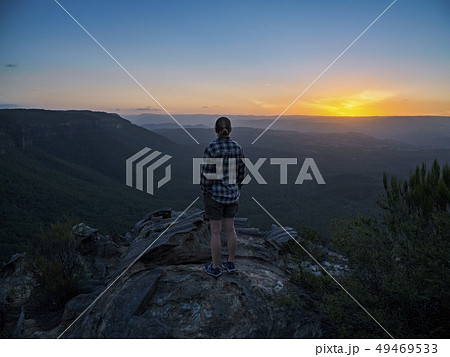 Woman standing on peak of Blue Mountains at sunrise in New South Wales, Australia Woman standing on peak of Blue Mountains at sunrise in New South Wales, Australia 49469533