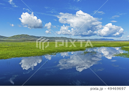 Clouds over river through fields in Fairfield, Idaho, USA 49469697