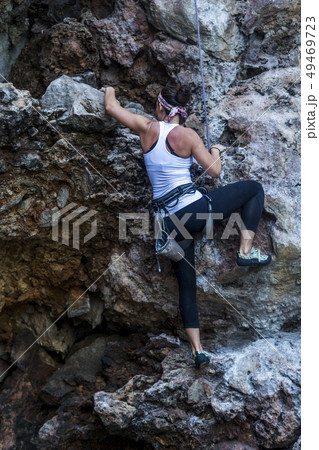 Woman rock climbing 49469723