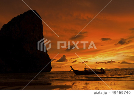 Silhouette of boat by cliff at sunset in West Railay, Thailand 49469740