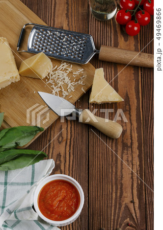 Pizza ingredients on wooden table Pizza ingredients on wooden table 49469866