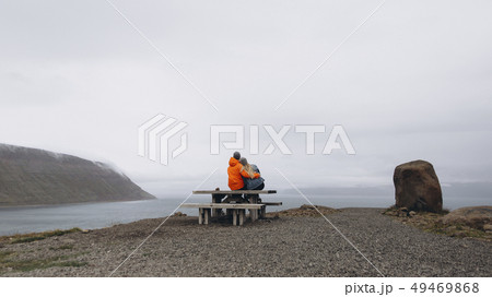 Couple sitting on picnic table 49469868