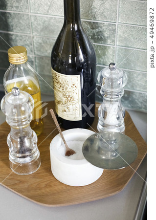 Oil, salt and pepper on tray in kitchen Oil, salt and pepper on tray in kitchen 49469872
