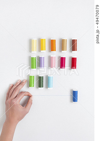 Woman's hand selecting thread Woman's hand selecting thread 49470079