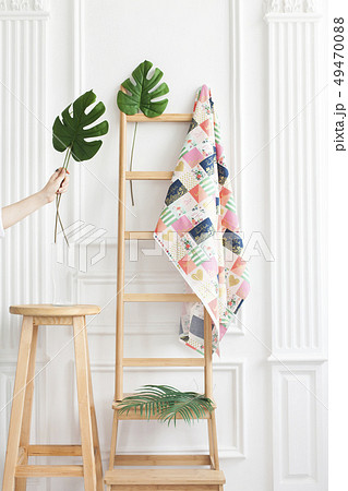 Fabric on rack with palm leaves Fabric on rack with palm leaves 49470088