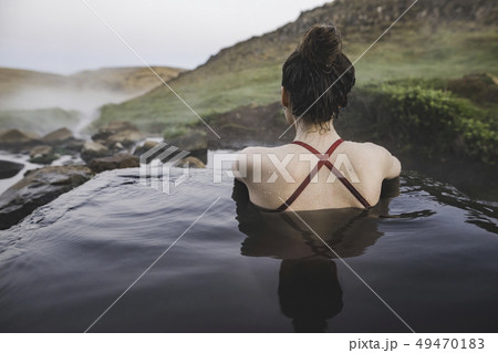 Rear view of woman in hot pool Iceland 49470183