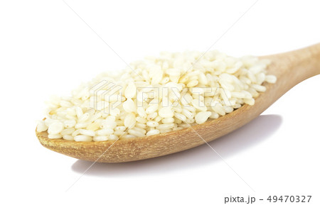 white sesame seeds in wooden spoon on white white sesame seeds in wooden spoon on white 49470327