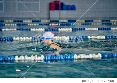Female athlete in a green-black swimsuit Female athlete in a green-black swimsuit 49471460