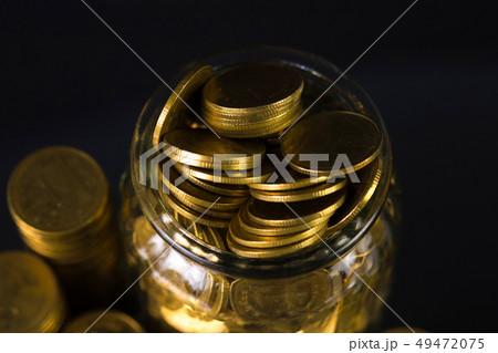 Coins stacks and gold coin money in the glass jar 49472075