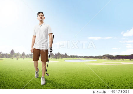 Asian man in white clothes holding iron golf club 49473032