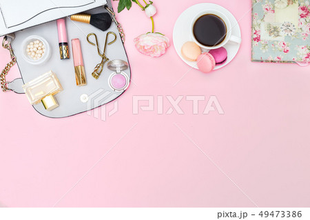 Cosmetics and accessories on a pink background. 49473386