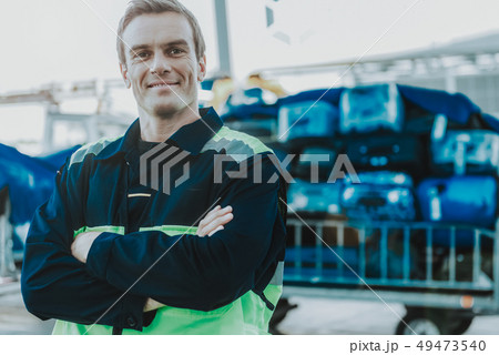 Handsome worker is standing in the airfield 49473540