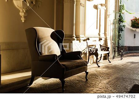 An old-fashioned armchair in the shade. Antique An old-fashioned armchair in the shade. Antique 49474702
