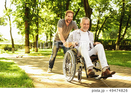 Outdoor Rehabilitation. Son and Old Man Have Fun. 49474826