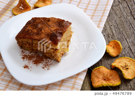 Apple pie with cinnamon on an old wooden 49476789