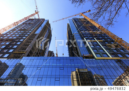 The glass facade, a reflection of the blue sky 49476832