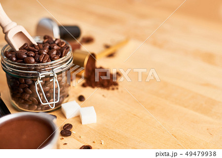 Freshly roasted coffee beans in a glass jar Freshly roasted coffee beans in a glass jar 49479938