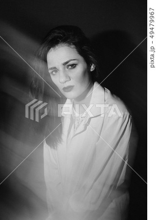 fashion portrait of Caucasian brunette girl posing in white shirt in Studio 49479967