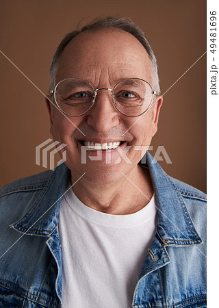 Smiling man wearing glasses with metal rim Smiling man wearing glasses with metal rim 49481696