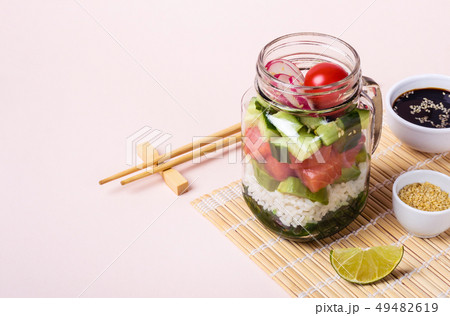 Hawaiian salmon poke salad in glass jar with rice 49482619