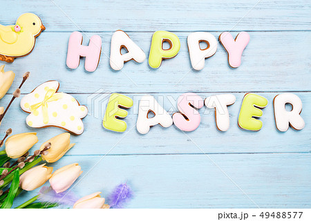 Delicious Easter cookies background. Eggs with different pattern icing on blue wooden background 49488577