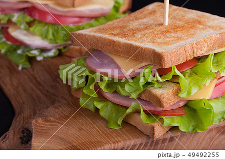 Big sandwich with ham and cheese. 49492255