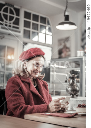 Elegant lady having breakfast in cozy cafe Elegant lady having breakfast in cozy cafe 49492460