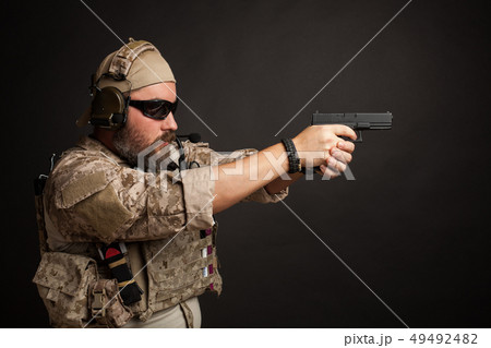 Brutal man aiming from his gun. 49492482