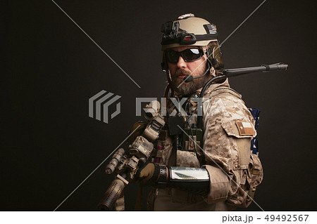 Brutal man in the military desert uniform. Brutal man in the military desert uniform. 49492567