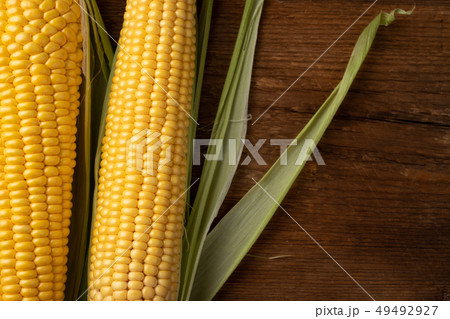 Fresh corn on cobs on rustic wooden table. Fresh corn on cobs on rustic wooden table. 49492927