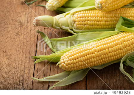 Fresh corn on cobs on rustic wooden table. 49492928