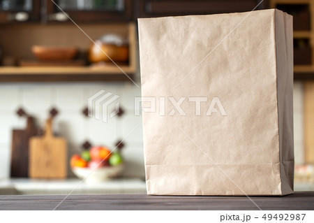 An empty paper bag on the kitchen table. An empty paper bag on the kitchen table. 49492987