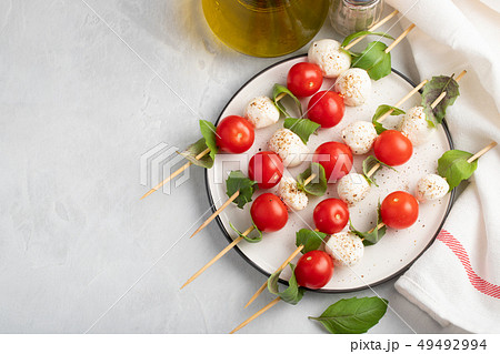 skewer with tomato, mozzarella and basil. 49492994
