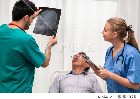 Doctor team work with x ray film image of patient. 49494859