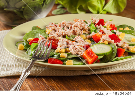 Fresh spinach salad with tuna, cucumber, corn, and Fresh spinach salad with tuna, cucumber, corn, and 49504034