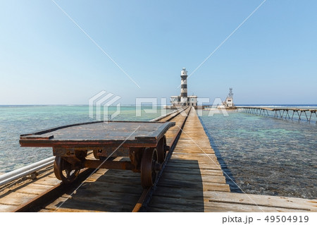Railcart on pier with lighthouse 49504919