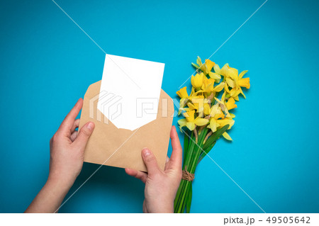 Office desk, spring concept. Women's hands hold 49505642