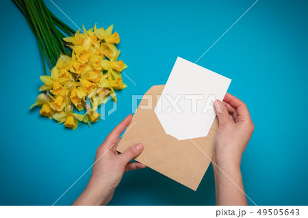 Office desk, spring concept. Women's hands hold 49505643