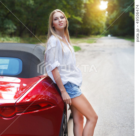 Young woman standing near a sports carの写真素材 [49506474] - PIXTA