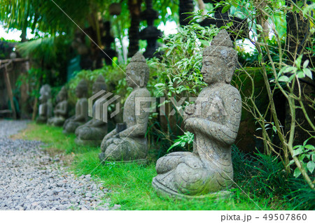 Stone religious sculpture covered by green moss in Goa Gajah Sanctuary. Bali, Indonesia 49507860