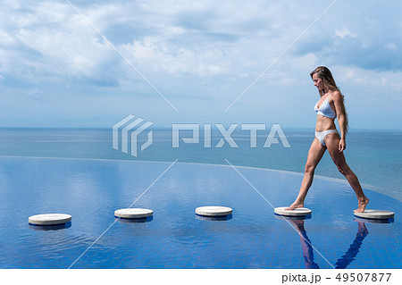 sexy girl. beautiful woman. model lady bikini underwear sit edge of water swim pool on the roof of sexy girl. beautiful woman. model lady bikini underwear sit edge of water swim pool on the roof of 49507877
