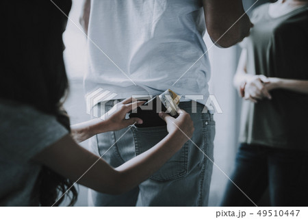 Parents Stand and Talk. Girl Pulls Out Wallet. 49510447