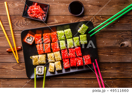 Sushi Set rolls with soy sauce served on black plate 49511660