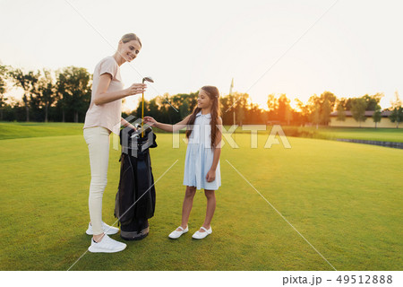 Woman Takes a Golf Club. Teaches the Daughter Woman Takes a Golf Club. Teaches the Daughter 49512888