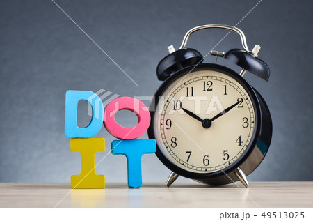 word DO IT on wooden desk over dark background word DO IT on wooden desk over dark background 49513025